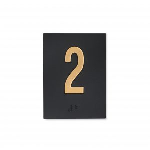Shows an embossed jamb braille plate with a number 2 on it in a satin bronze finish and a black background